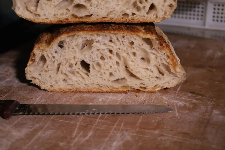 A loaf cut in half, the open crumb