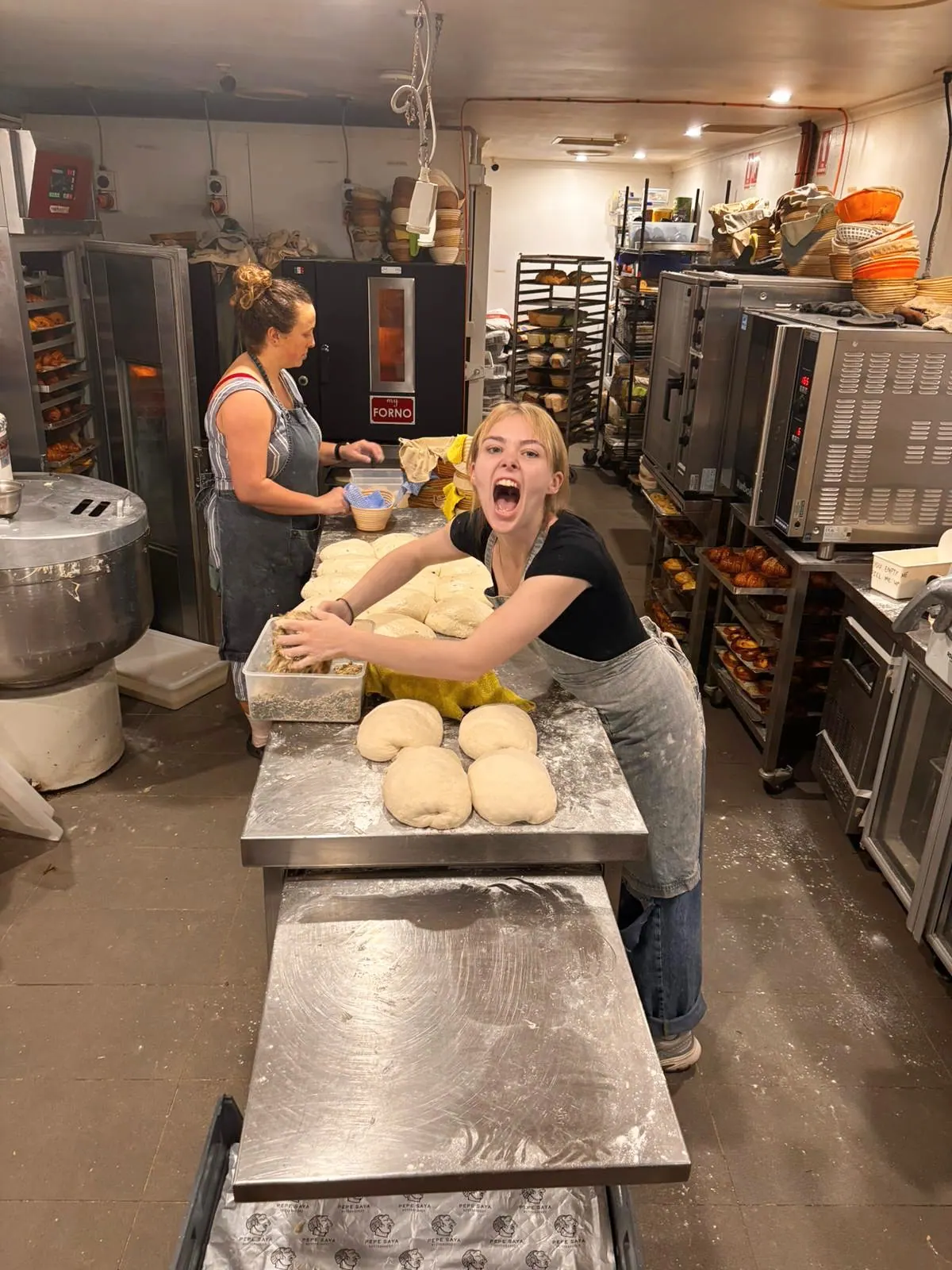 The Peach & Wolf bakers shaping dough beside their MyForno oven